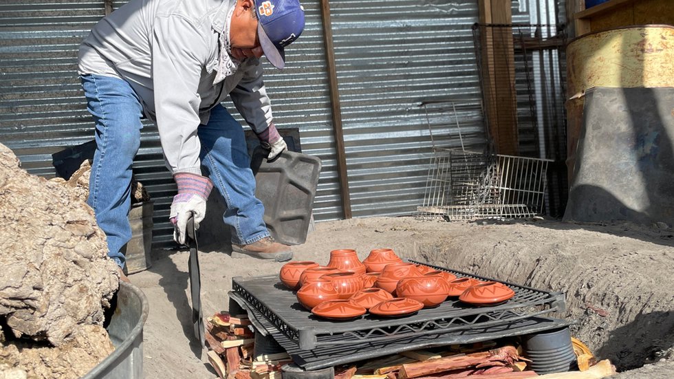 AC-1-Marvin-Martinez,-Maria-Martinez's-great-grandson,-puts-the-final-touches-on-the-family's-firebit-base.-Red-cedar-is-chosen-for-kindling-for-its-abundance-and-its-tolerance-of-extra-hot-temperatures.jpg